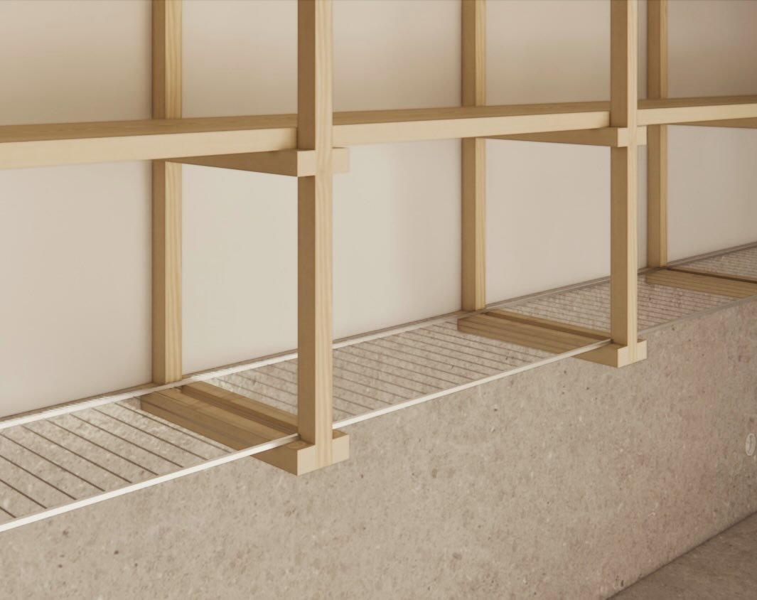 Close-up of a wooden rack with wire shelves mounted on a wall above a textured stone surface.