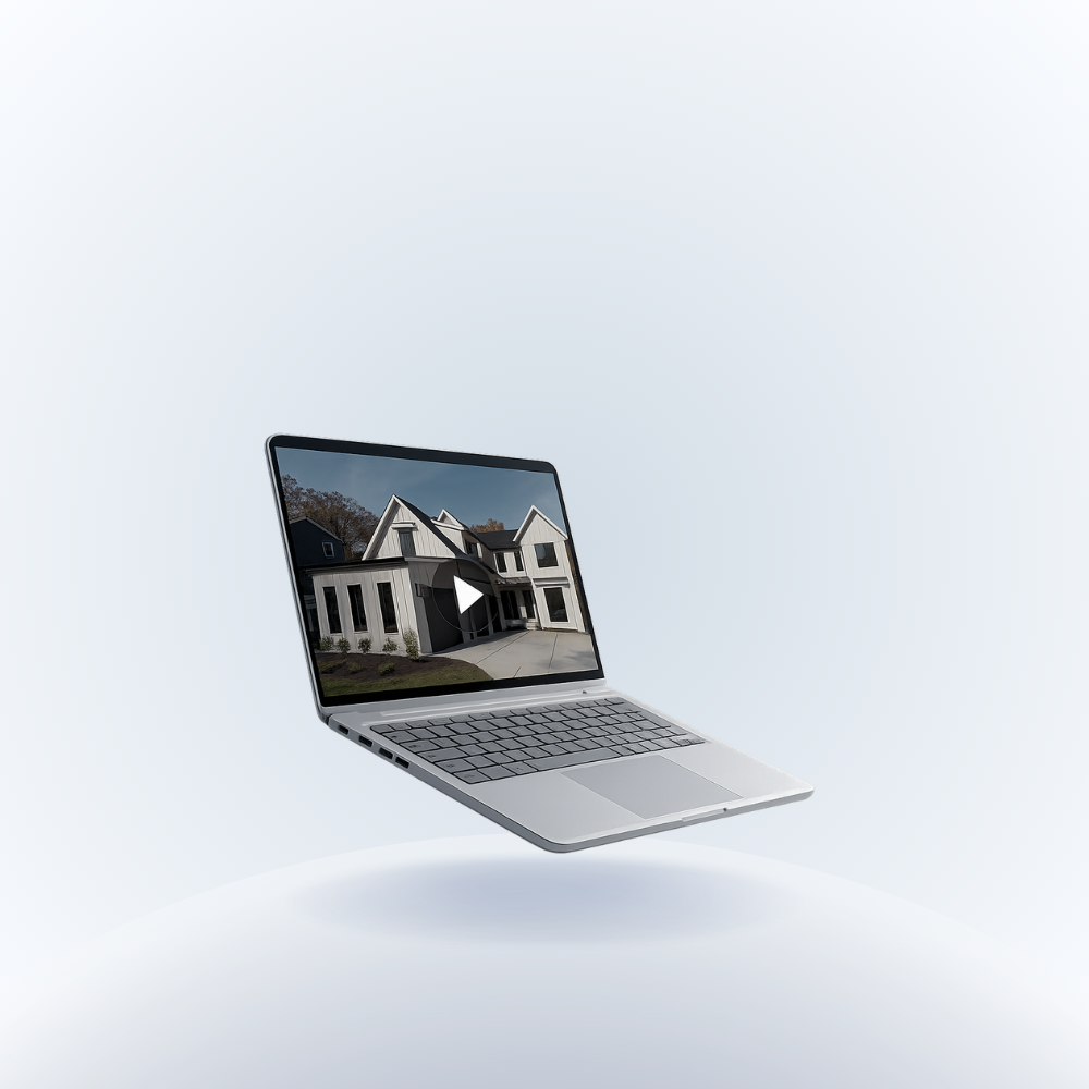 Laptop displaying a video of a modern house, floating above a white surface.