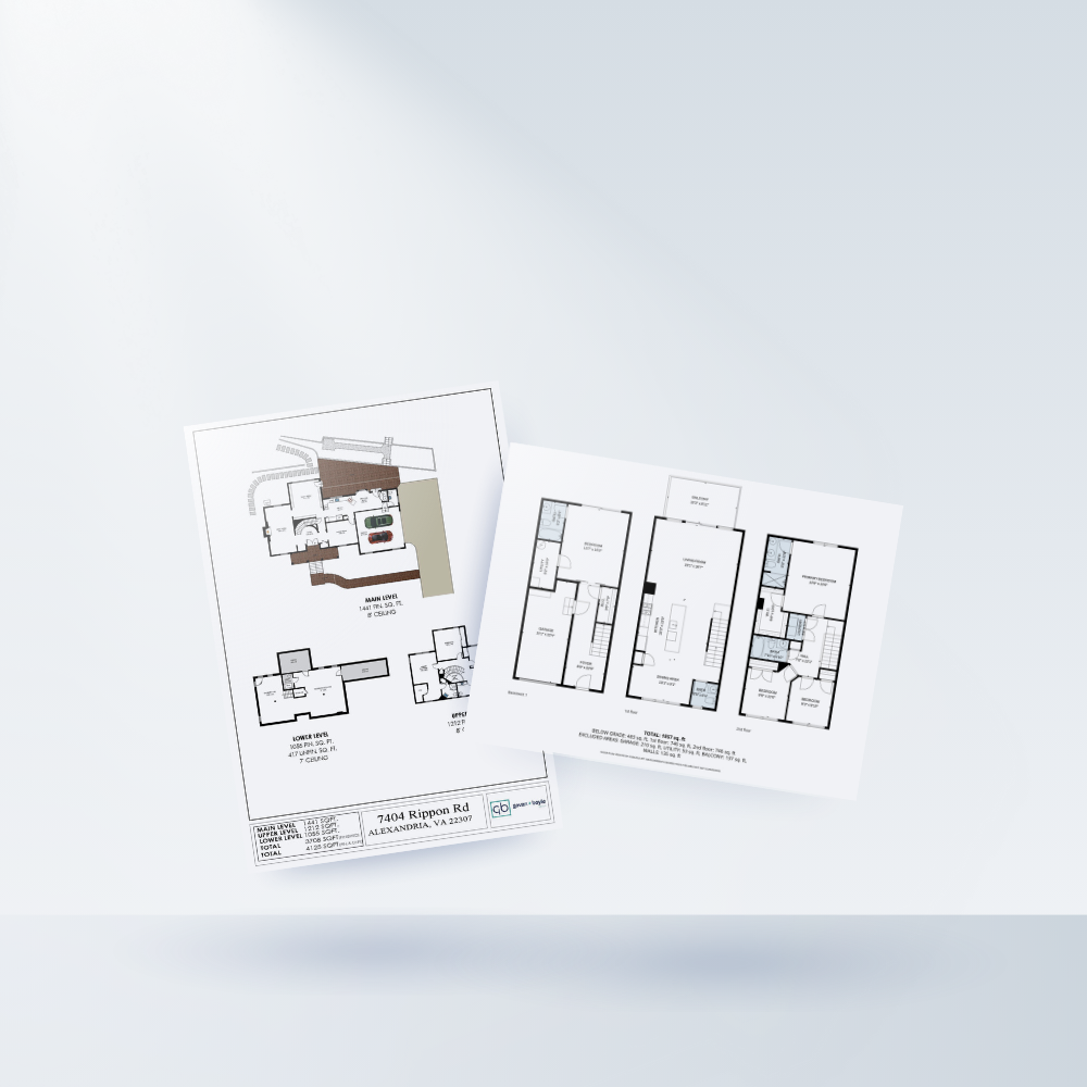 Two architectural floor plan sheets for a house showing different levels, on a white surface.