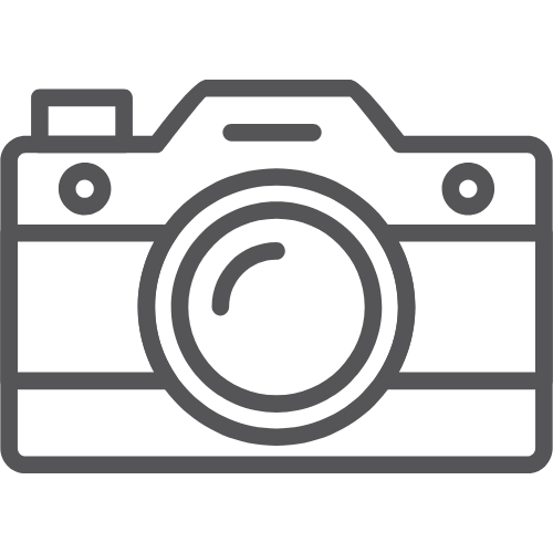 Placeholder icon of a camera with a lens in the center.