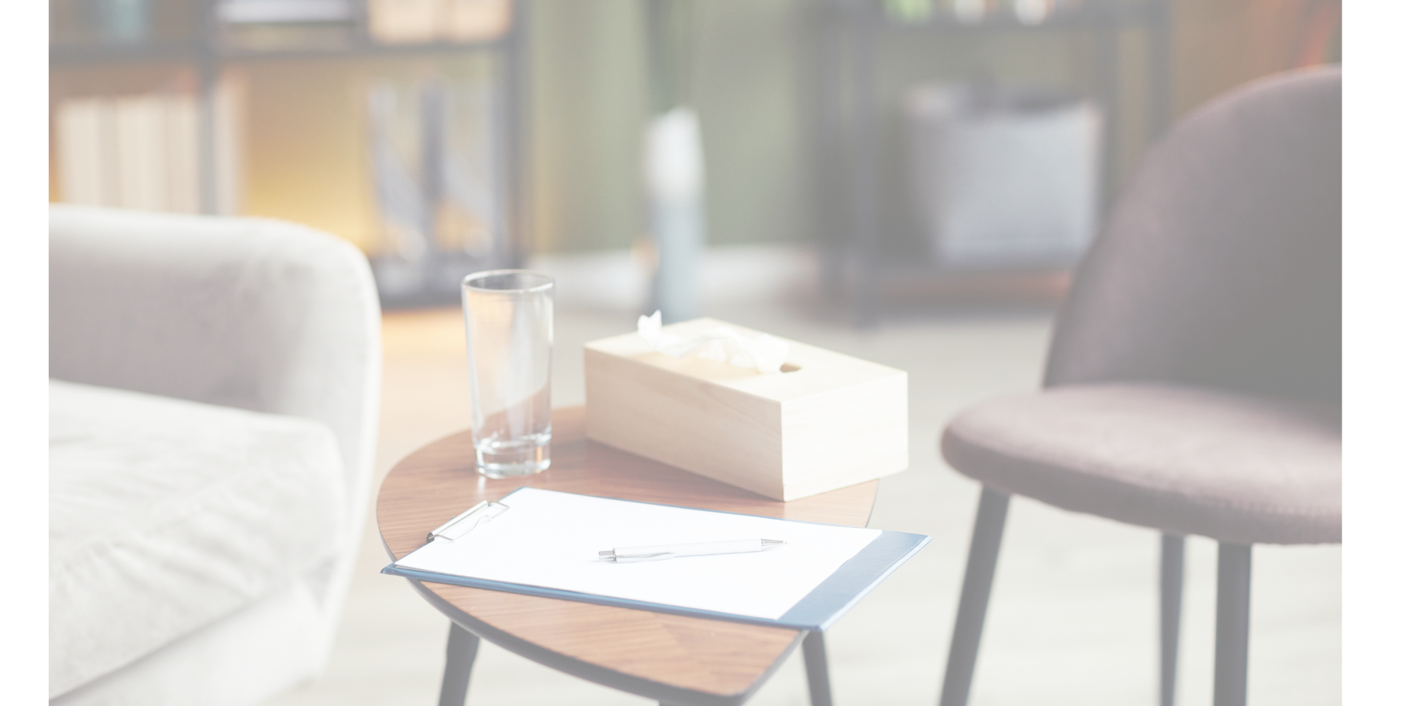 2 empty seats with a table holding tissues