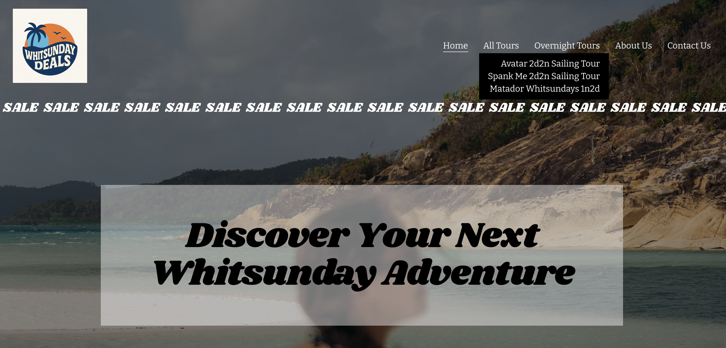 Website homepage for Whitsunday Deals, featuring a beach scene with a rocky coastline, ocean waves, and an overcast sky. Navigation menu includes Home, All Tours, Overnight Tours, About Us, Contact Us, with dropdown options for sailing tours and Whitsundays activities. The page has a bold headline: 'Discover Your Next Whitsunday Adventure' and a repeated sale banner for discounts.