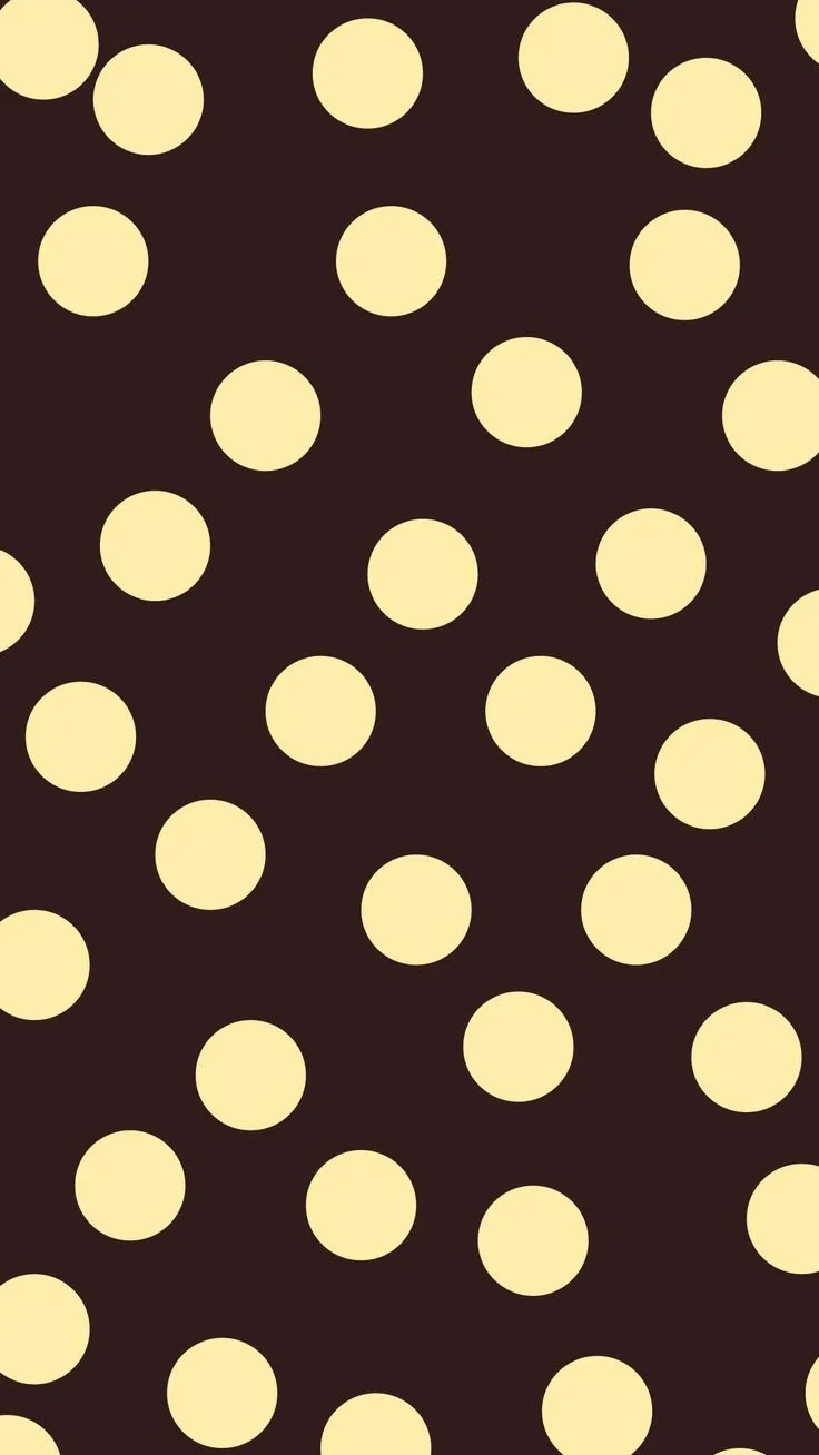 Pattern of light yellow circles evenly spaced on a dark brown background.