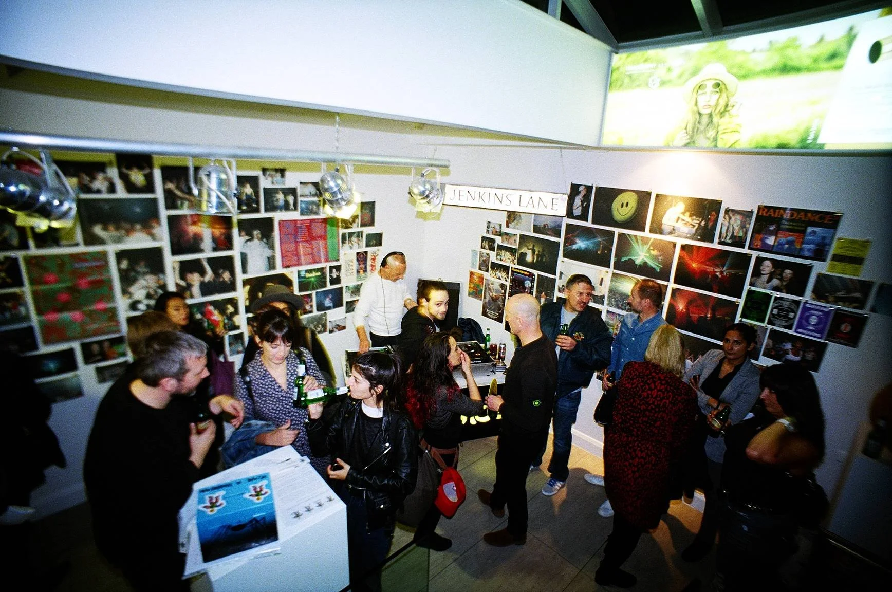 Visitors at Cult to Culture exhibition and archive event surrounded by photography and printed works