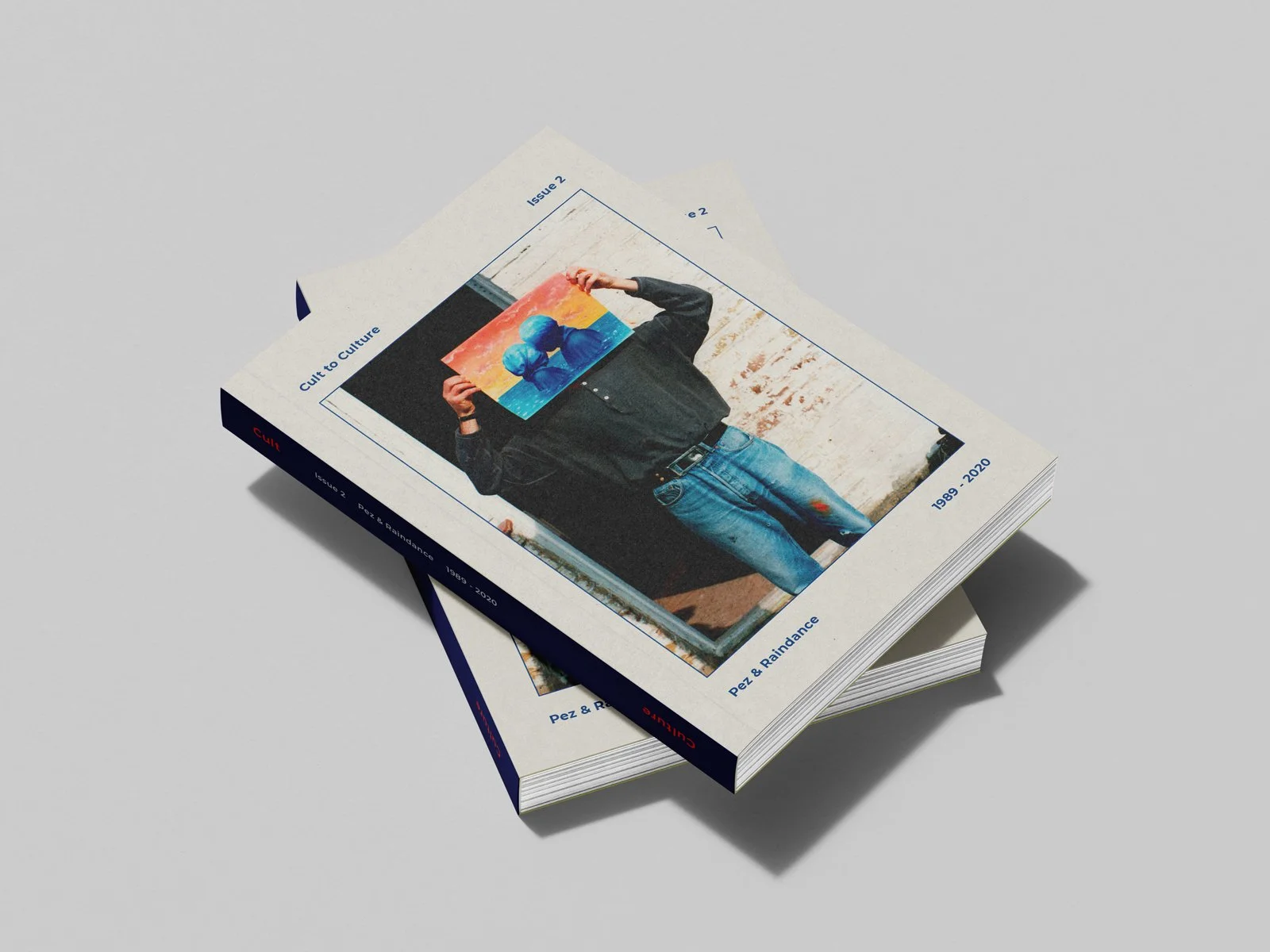 Stack of Cult to Culture Issue 2 publications photographed on studio background