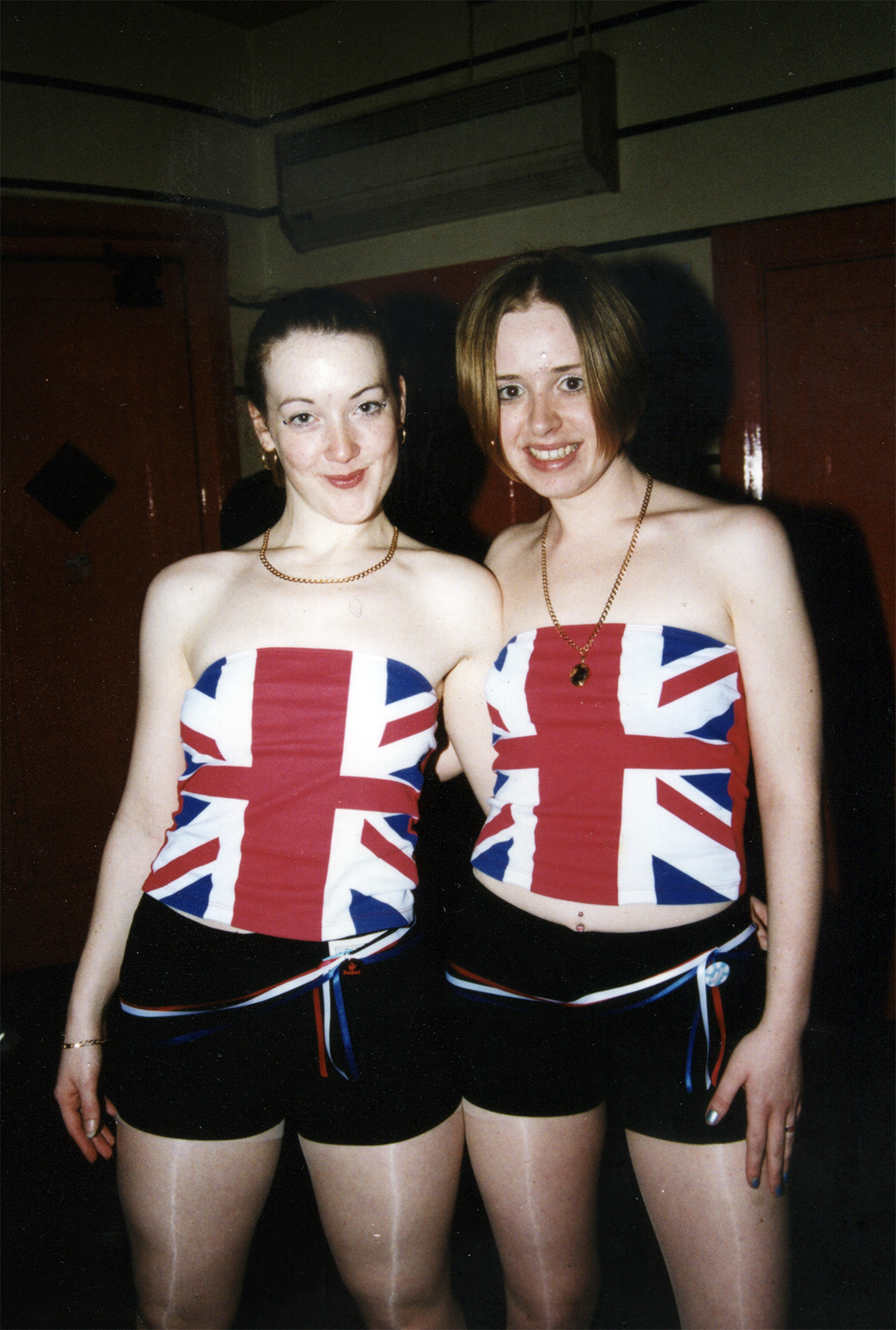 Two women wearing Union Jack tops photographed at UK rave event
