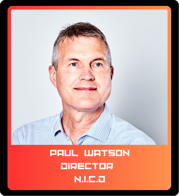 Portrait of a middle-aged man with short light brown hair, wearing a light blue striped shirt, against a neutral background.