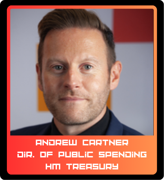 A headshot of a man with short brown hair and a light beard, wearing a dark suit and black shirt, against a gray background with orange accents.