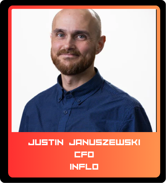 Portrait of Justin Januszewski, CFO, INFLU. He has a beard and is wearing a dark blue button-up shirt, smiling against a white background.