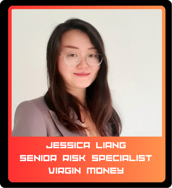 Professional woman with glasses and long dark hair smiling, wearing a blazer.