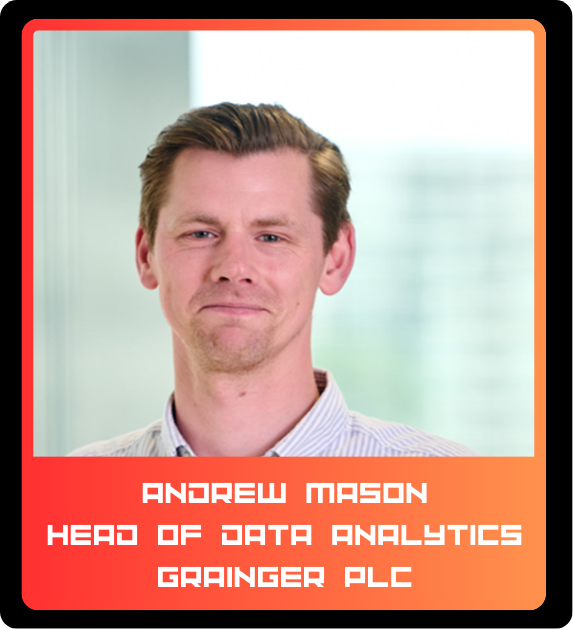Portrait of a man with short light brown hair, wearing a light-colored collared shirt, standing indoors with a blurred window in the background.