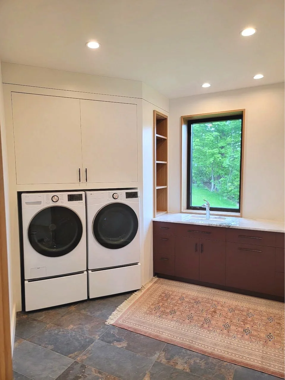 Laundry room casework designed to maximize storage while maintaining a calm, uncluttered appearance.