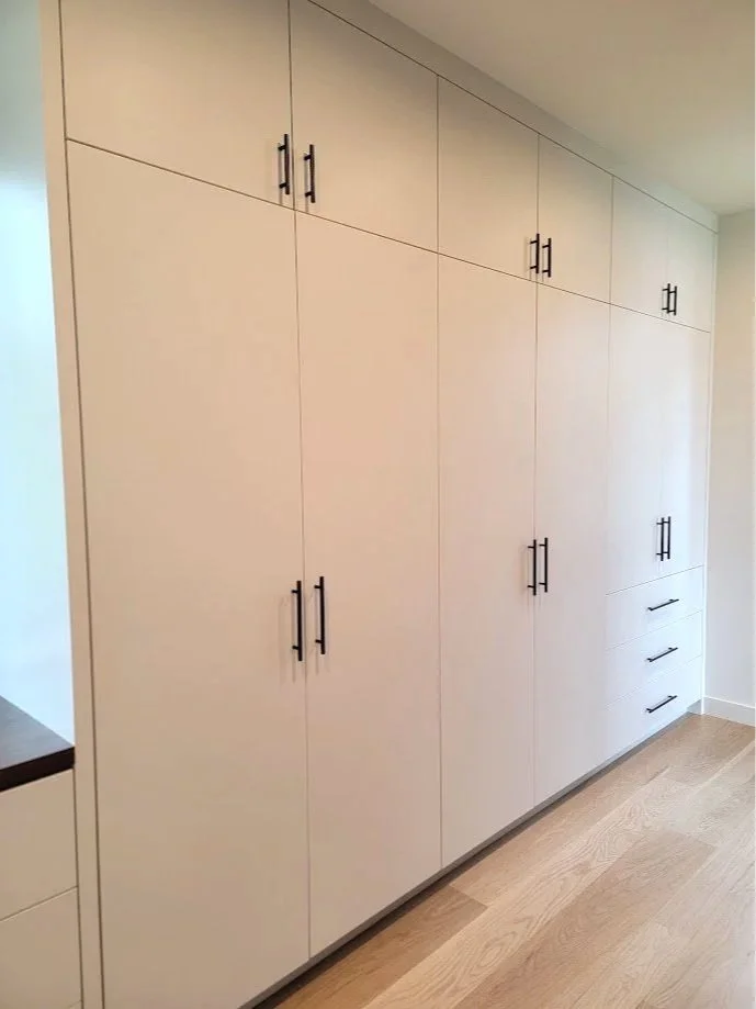 Closet cabinetry detailed to maintain visual continuity while supporting varied storage needs.