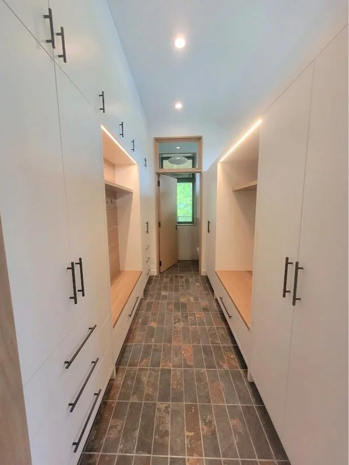 Mudroom casework designed for daily use, combining durable storage with clean-lined modern detailing.