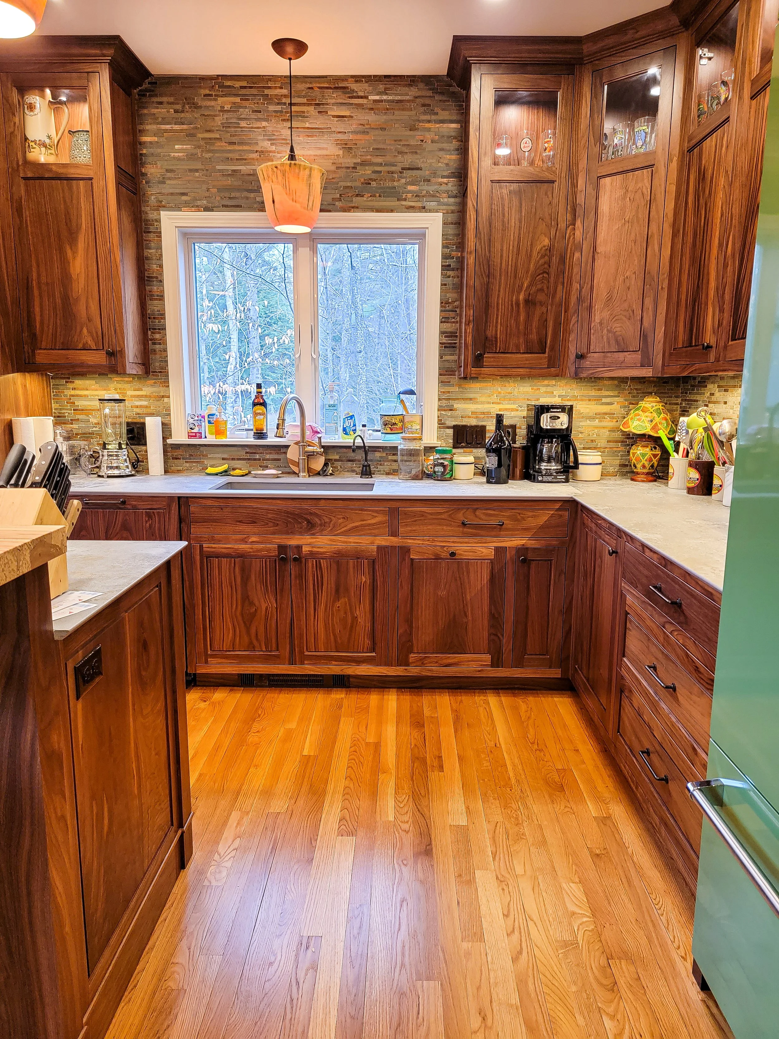 High-end kitchen with custom walnut cabinetry, built-in storage, and clean transitional design in Grantham NH