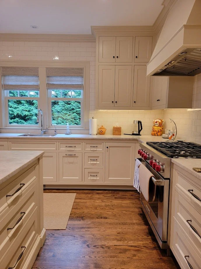 Beaded inset doors with traditional profiles and concealed soft-close hardware.