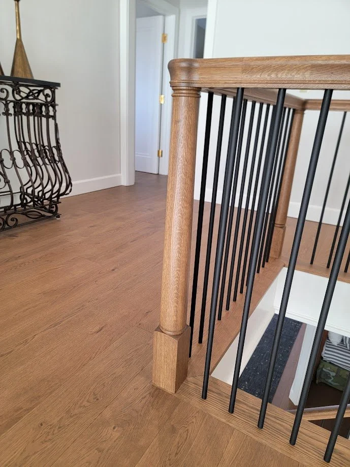 Turned solid wood newel post crafted as part of the home’s integrated architectural millwork package.