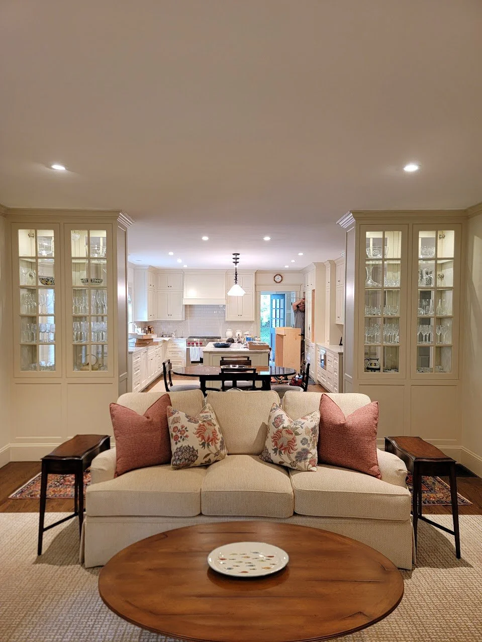 Coordinated millwork linking the living room and kitchen through consistent scale, finish, and detailing.