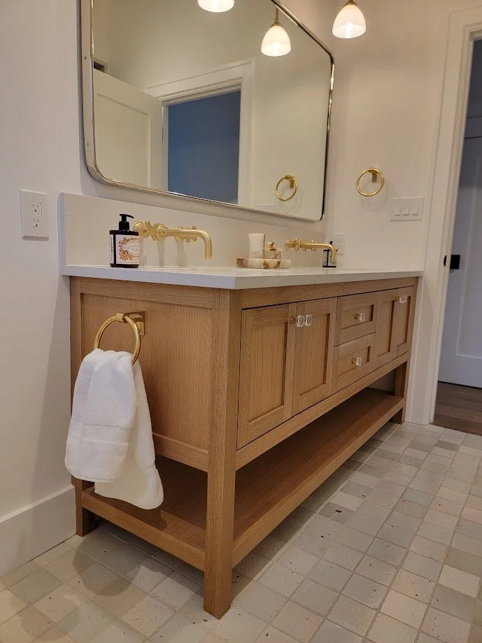 Guest bathroom vanity detailed to align with the home’s transitional millwork language.