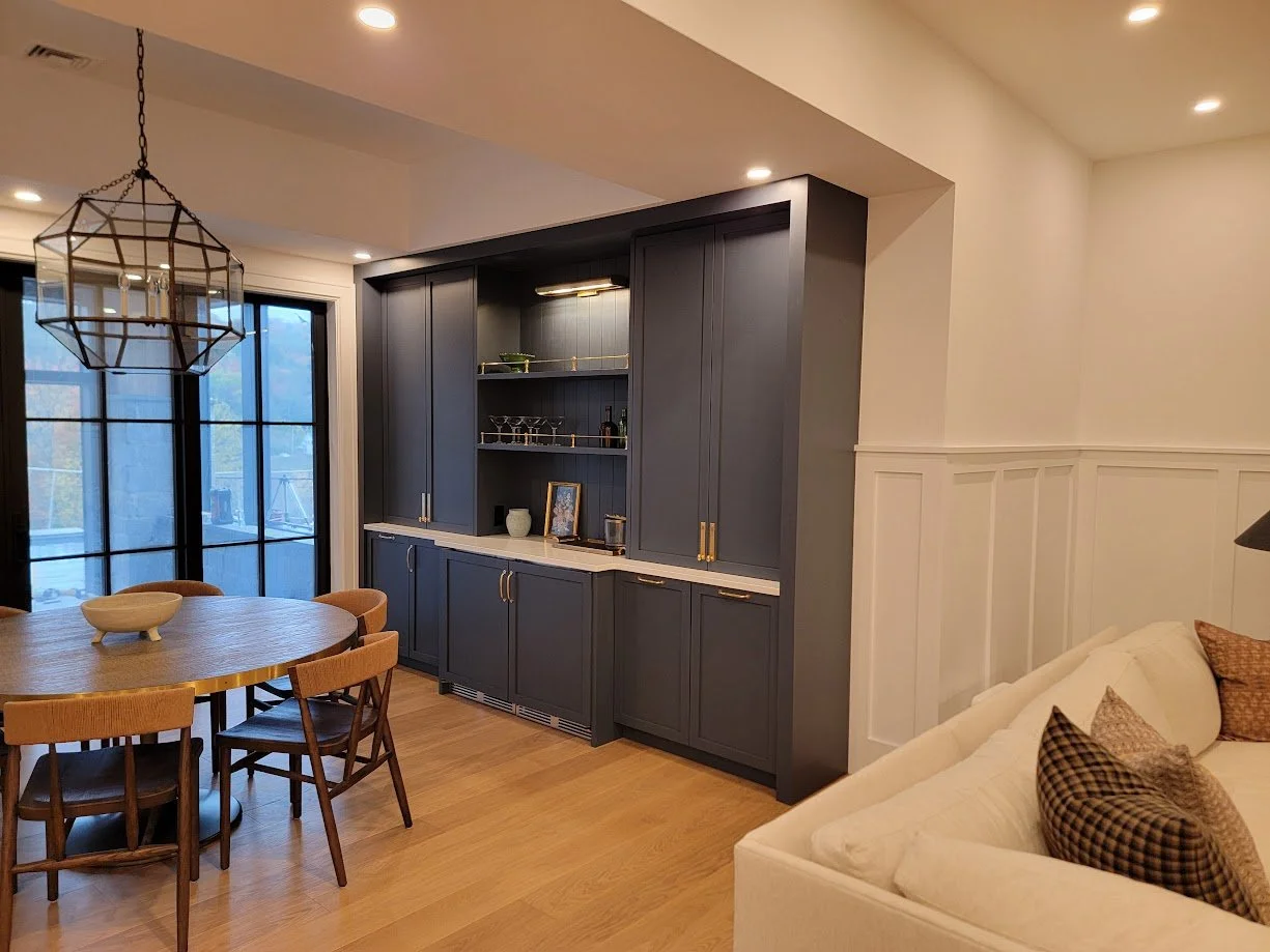 Built-in basement bar designed for entertaining, with integrated storage and relaxed, mountain-appropriate proportions.