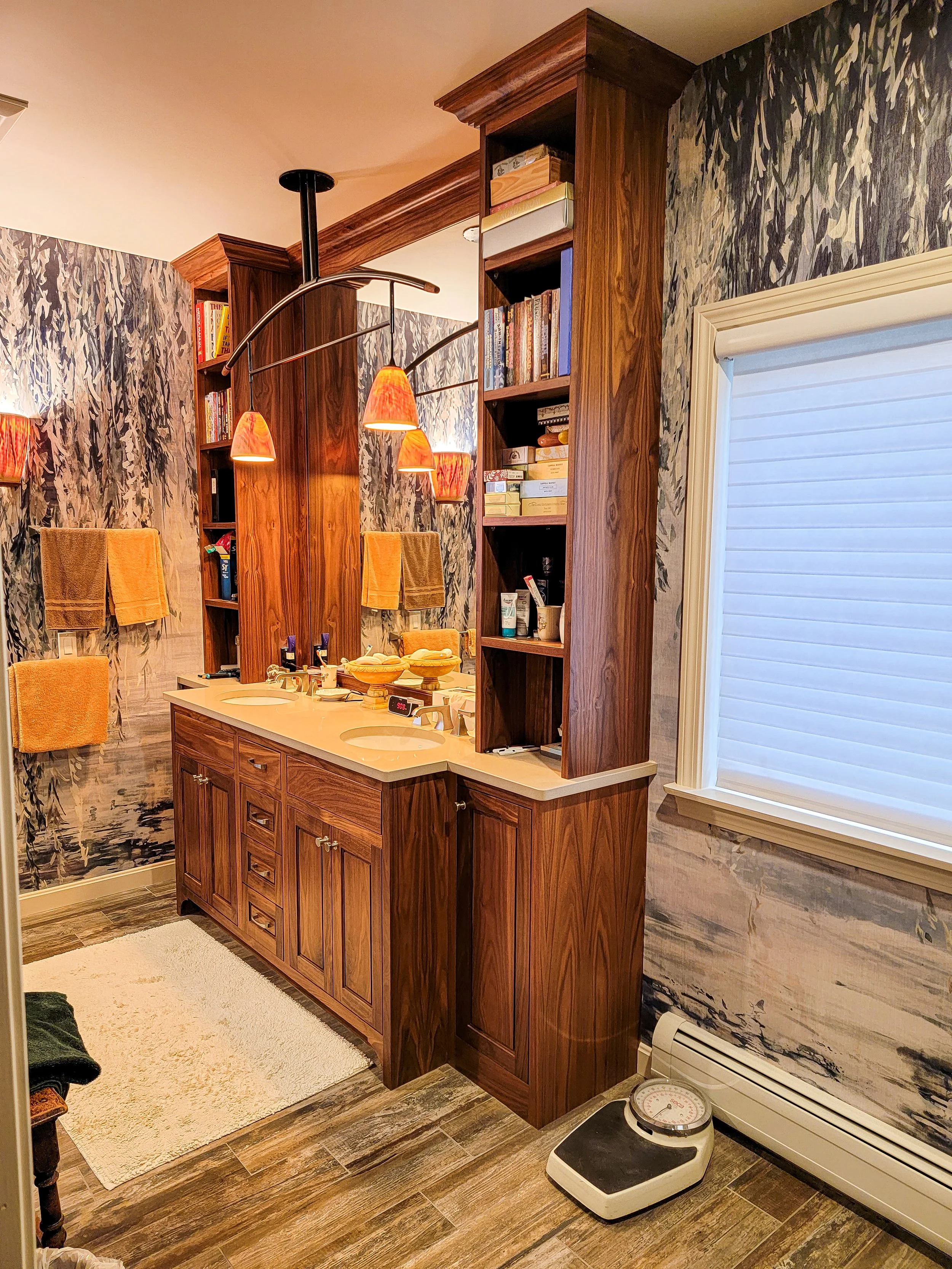 Custom walnut bathroom vanity with inset cabinetry and stone countertop in Eastman Community home, Grantham NH