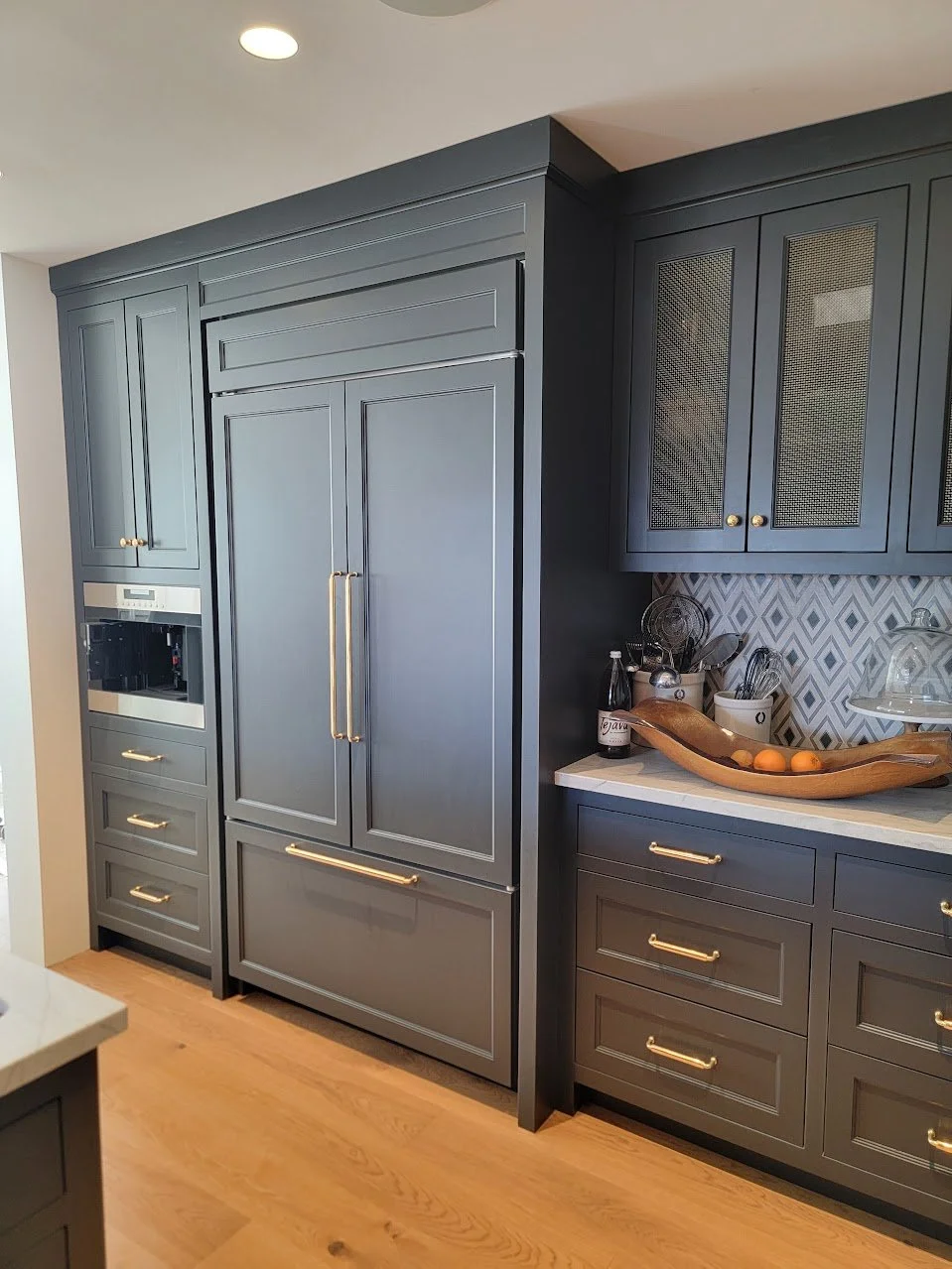 Charcoal black transitional kitchen with integrated refrigerator panels and custom cabinetry in this Quechee Lakes Vermont golf retreat.