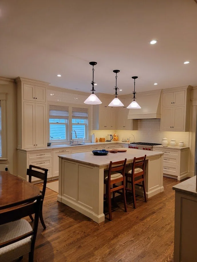 Formal inset kitchen with painted cabinetry, beaded frames, and custom crown molding