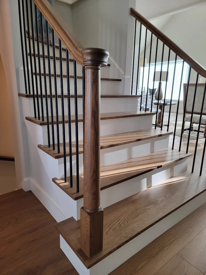 Custom turned newel posts anchoring the staircase, designed and fabricated for cohesive whole-house millwork.