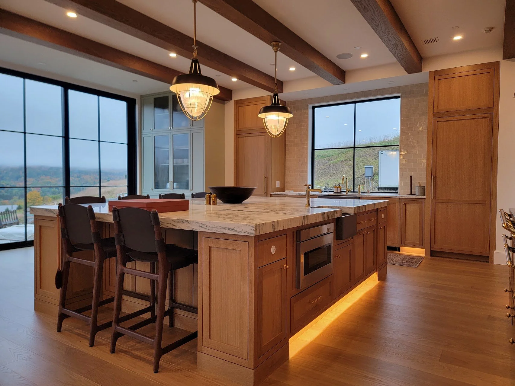 Large custom white oak kitchen in Quechee Vermont with expansive island and modern cabinetry.