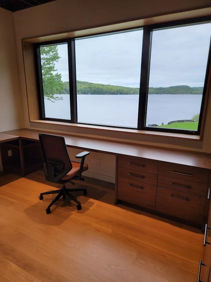 Integrated office millwork providing functional storage within a composed, modern workspace.