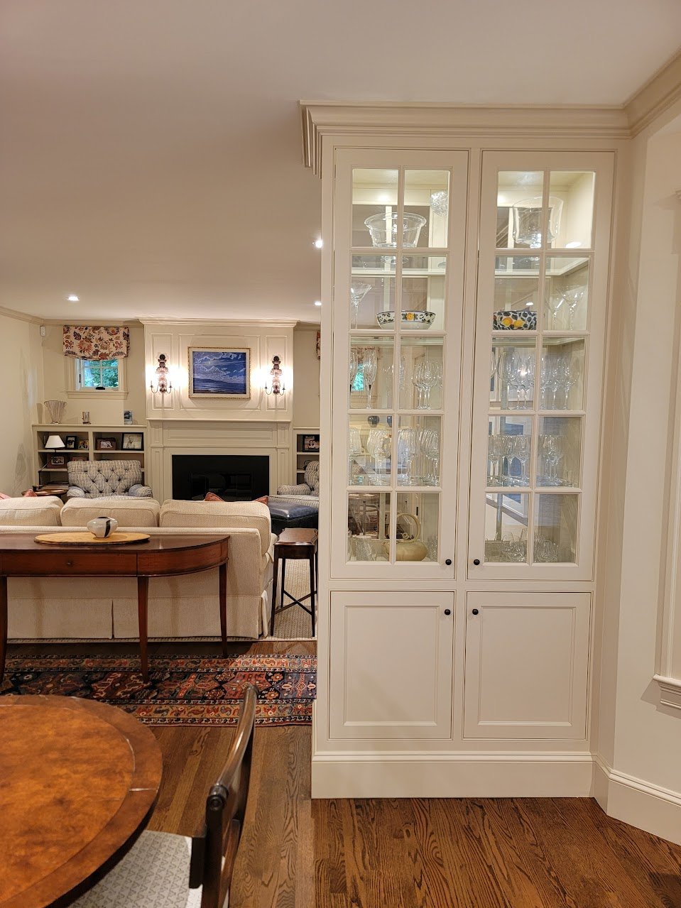 Furniture-style china hutch detailed to complement adjacent cabinetry and traditional interior finishes.