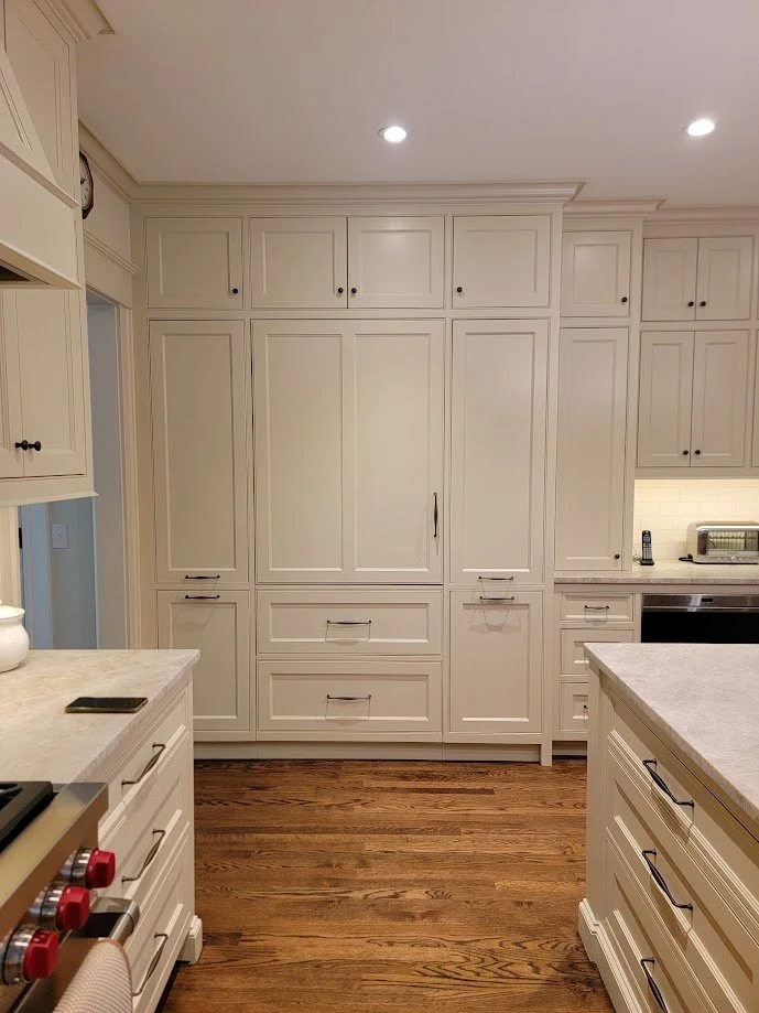 Full-height pantry cabinetry designed to align with adjacent architectural openings.