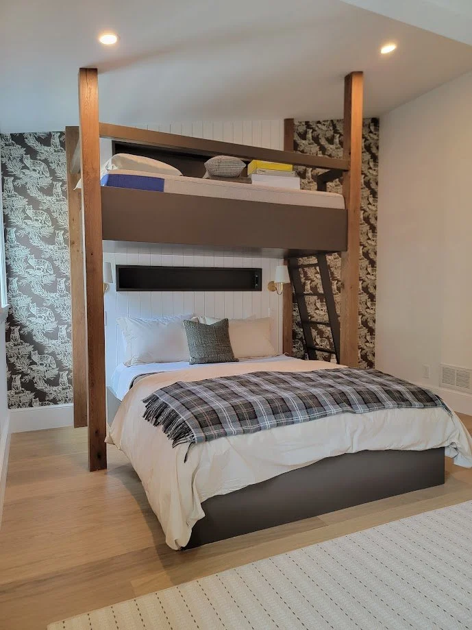 Custom bunk bed designed to accommodate guests comfortably while maintaining a cohesive, built-in appearance.