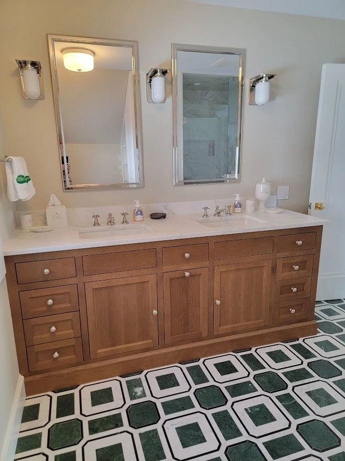 Custom oak-stained bathroom vanity with tailored storage and clean transitional detailing.