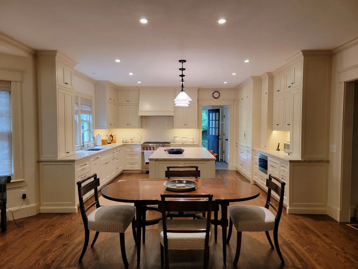 Formal inset kitchen with painted cabinetry, balanced elevations, and integrated panel-ready appliances.