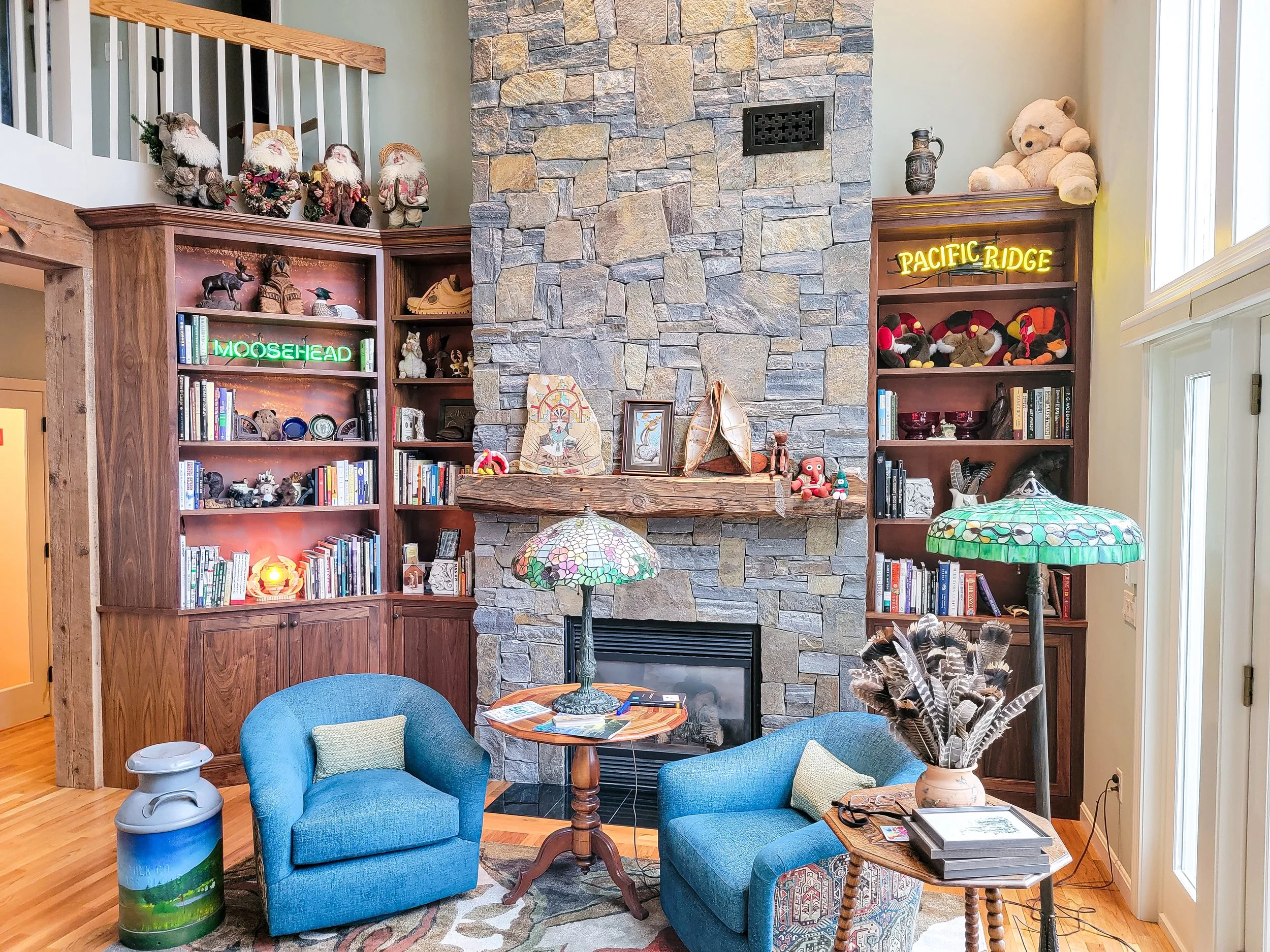 Custom walnut built-in bookcases with integrated storage and display shelving in Eastman Community home, Grantham New Hampshire