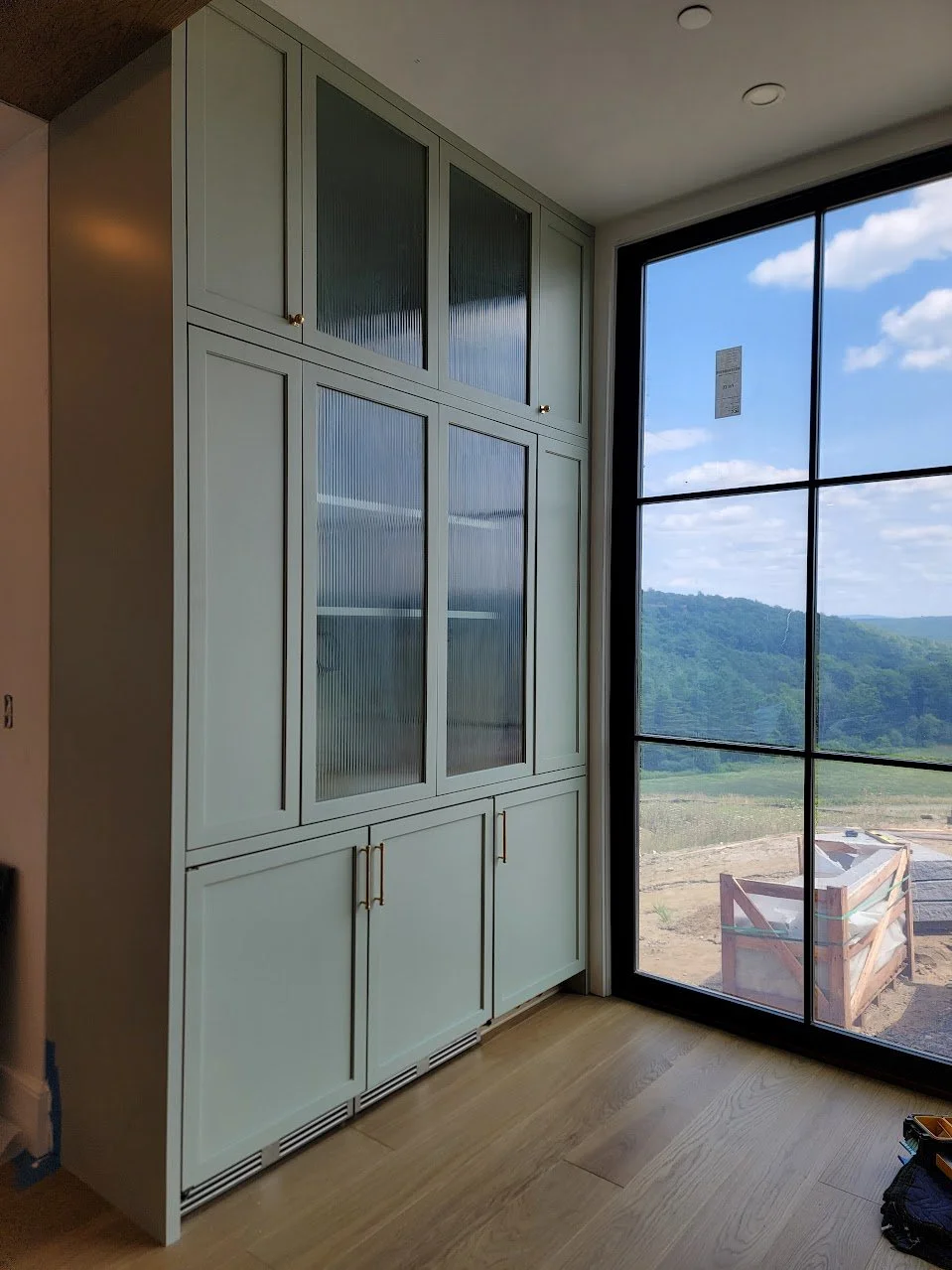 Built-in bar positioned off the main kitchen workspace to support entertaining without disrupting the primary cooking area.