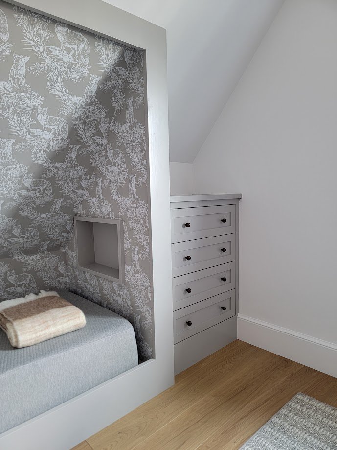 Custom bed millwork designed to comfortably host a large family and visiting friends.