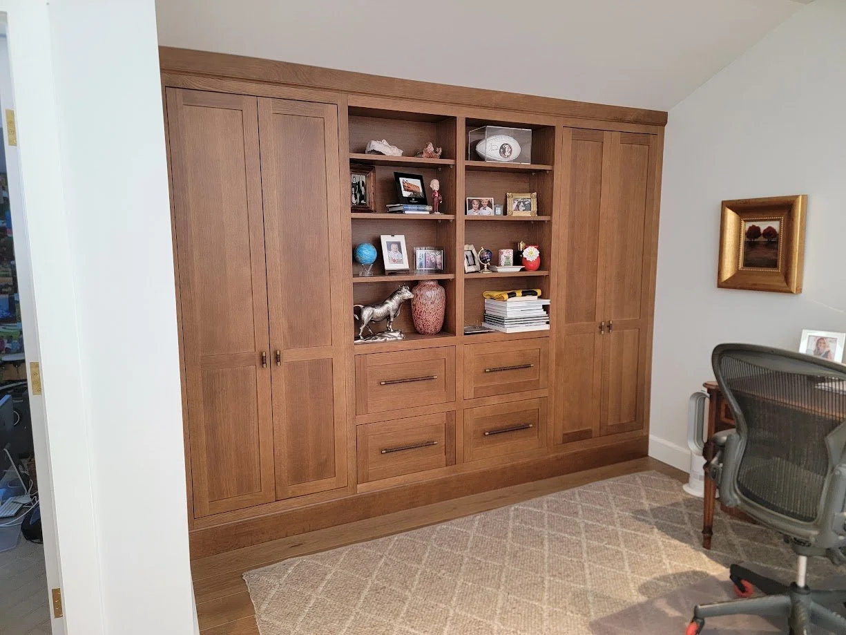 Custom oak home office cabinetry featuring built-in storage, workspace integration, and cohesive millwork design.