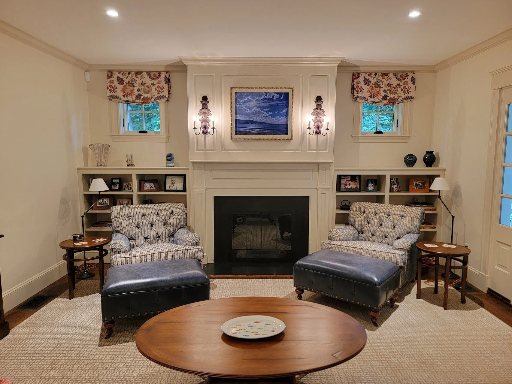 Fireplace surround and flanking bookcases designed as a unified architectural focal point.