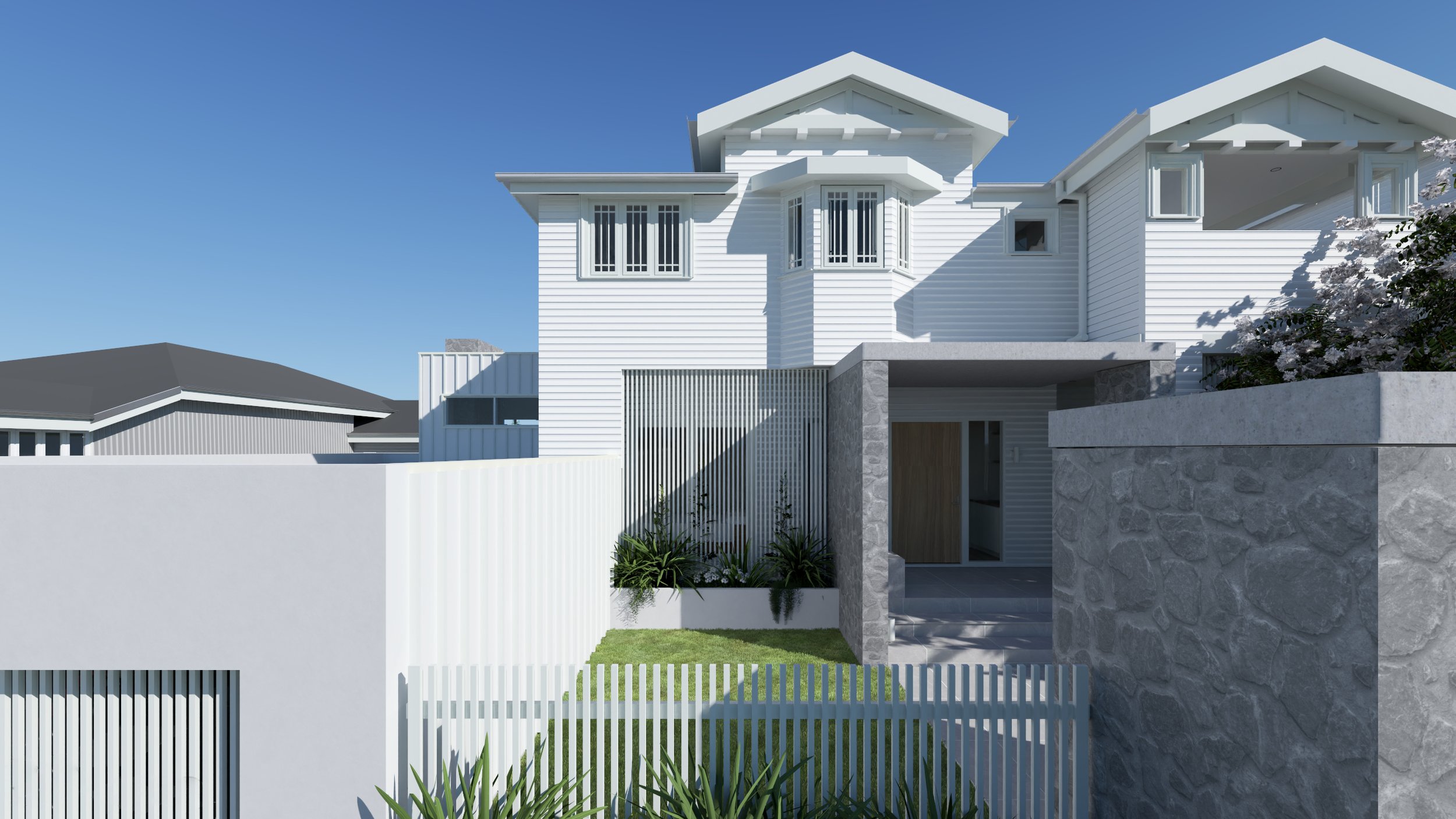 Modern white house with multiple gabled roofs, surrounded by a white fence and stone walls, with landscaped lawn and plants in front.