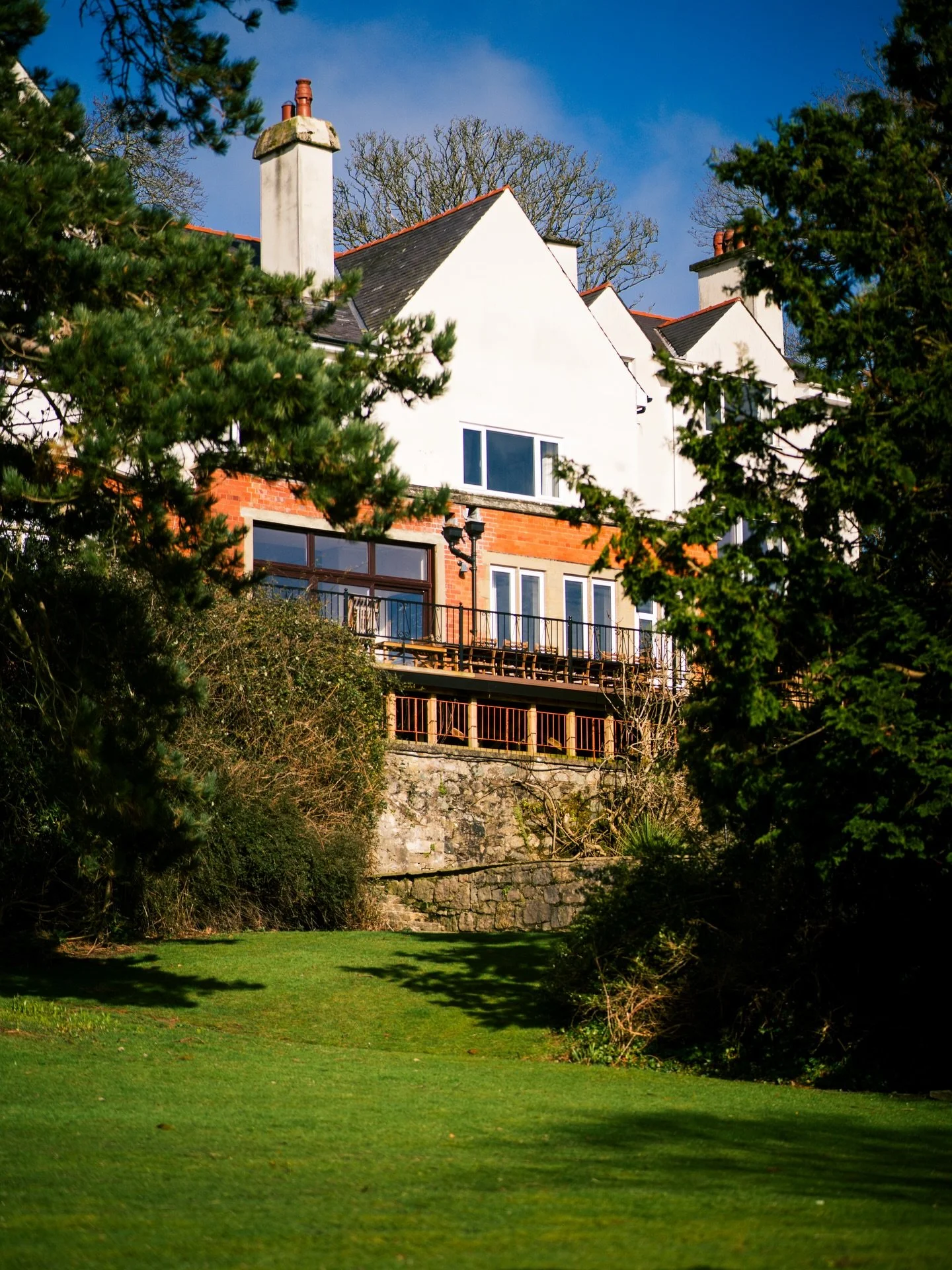 Seven individually designed bedrooms, each named for a piece of Anglesey and Welsh history. Five acres of private grounds, an arboretum planted by Sir Isham himself, and the Menai Strait at the bottom of the garden. Dog friendly. Space for sixteen. A