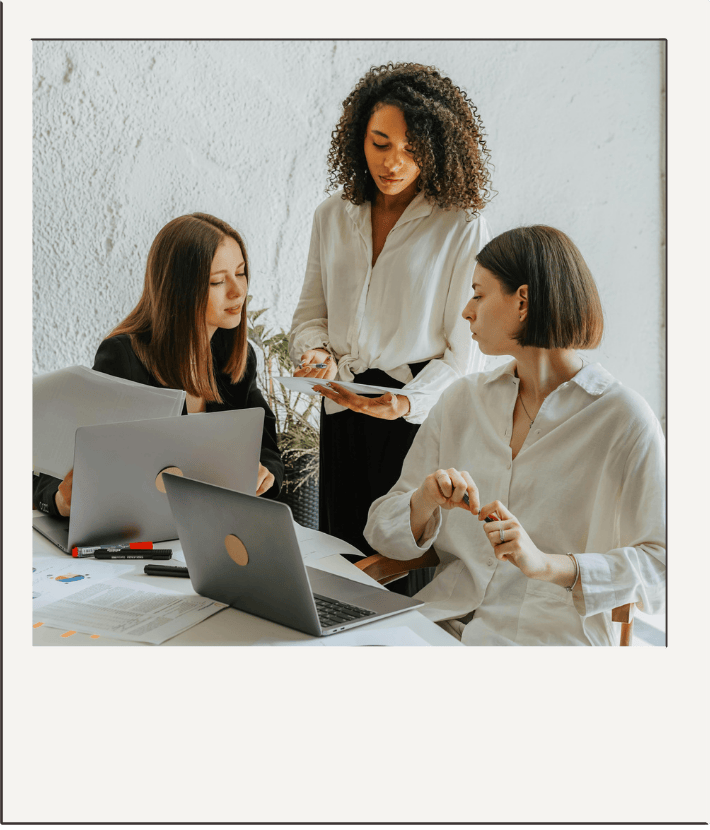 polaroid style photo of a group of women at workshop.
