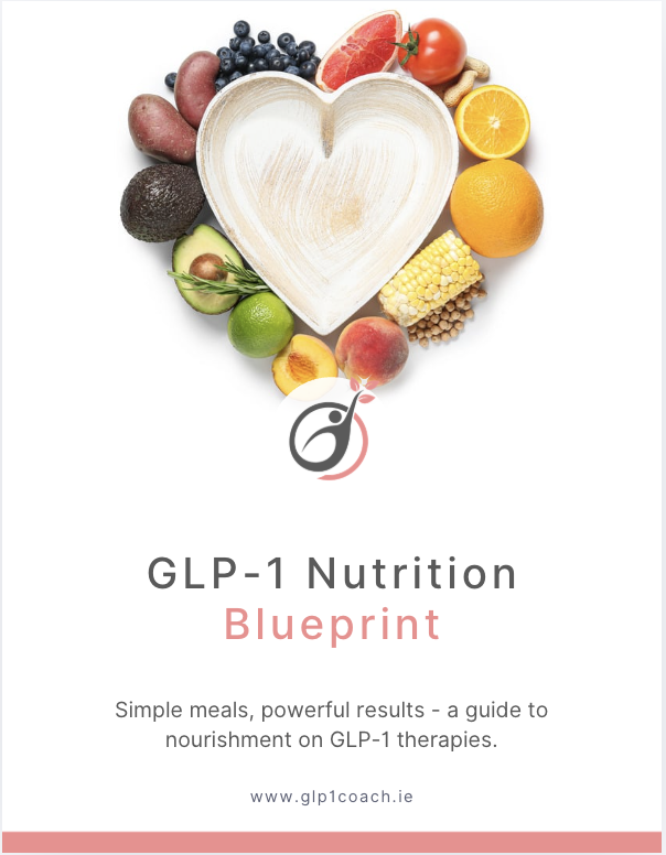 Heart-shaped plate surrounded by various fruits including blueberries, grapefruit, cherry tomato, orange, banana, avocado, lime, peach, and corn on the cob.