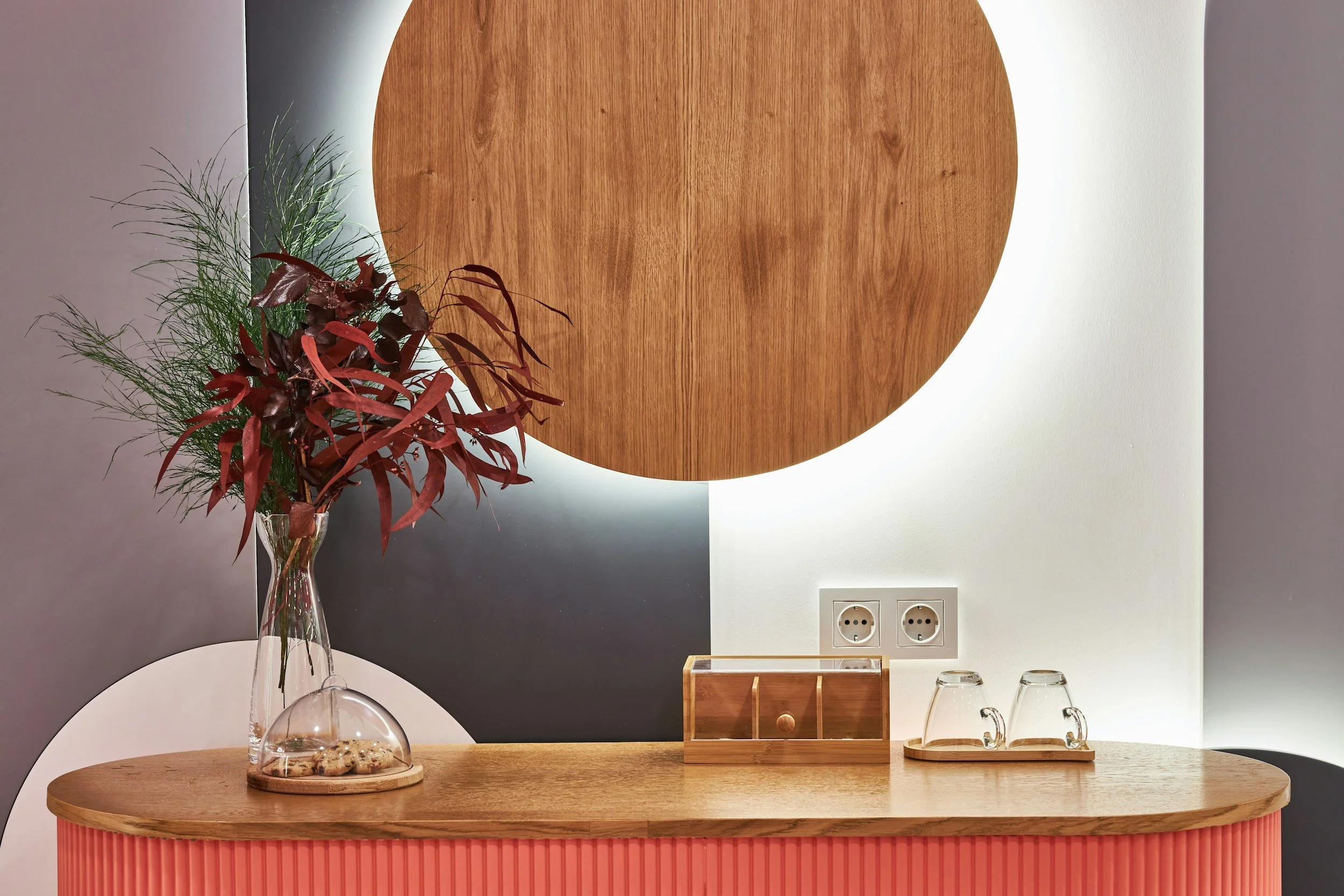 Close-up of a young green plant sprouting from soil, with a blurred background in warm tones.