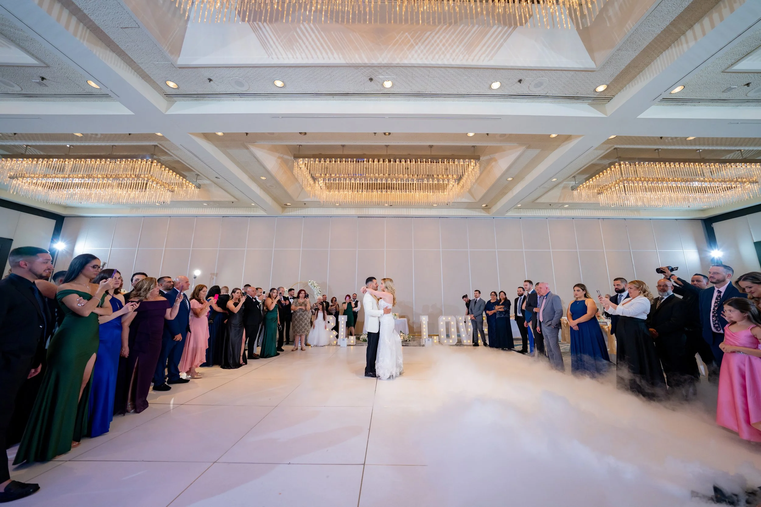 Grand wedding reception ballroom at HILTON TAMPA DOWNTOWN; professional photography of the first dance and venue decor by Star Visual Art, Tampa.
