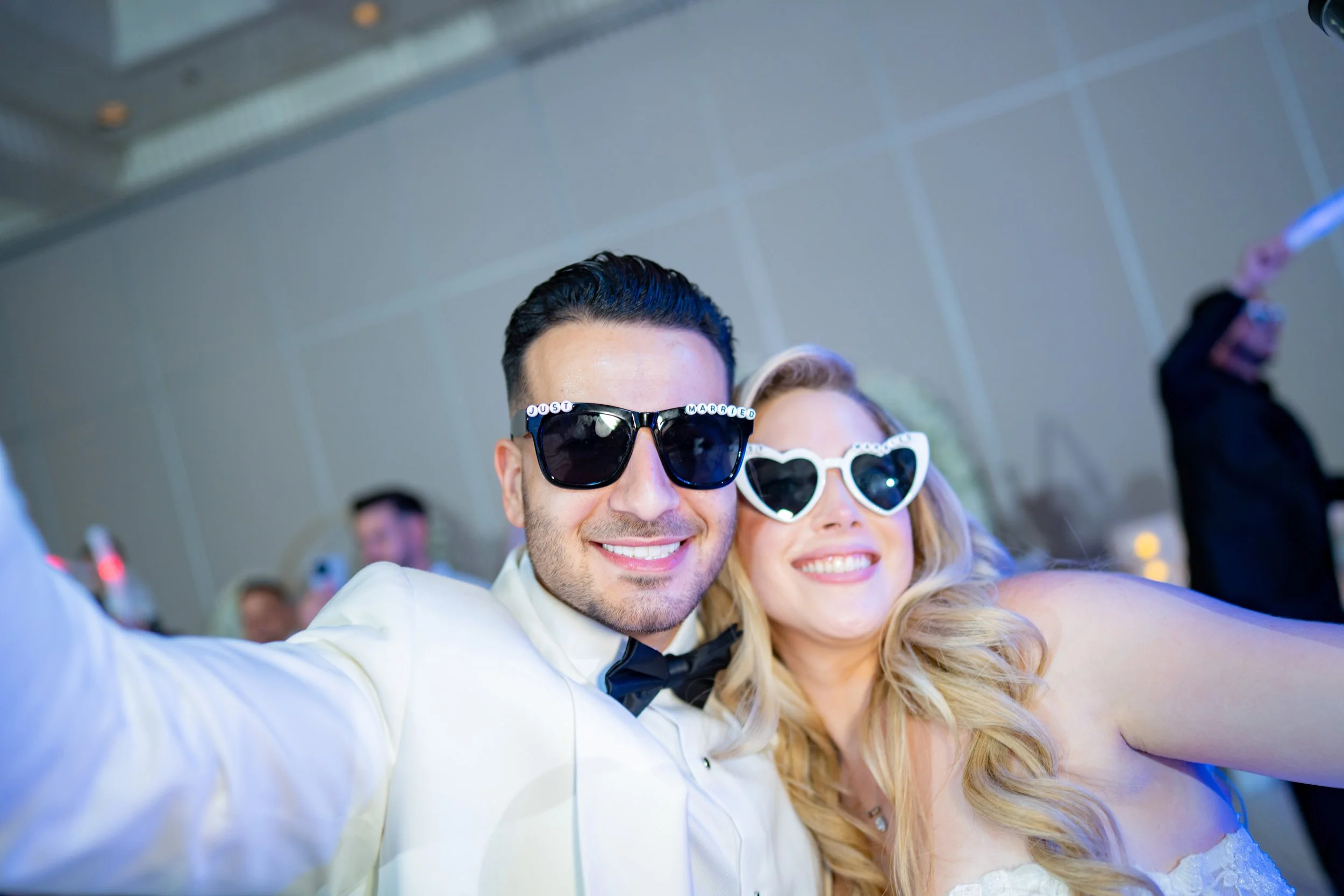 Cool bridal couple wearing sunglasses at their HILTON TAMPA DOWNTOWN reception; trendy and modern wedding party photography by Star Visual Art, Tampa.