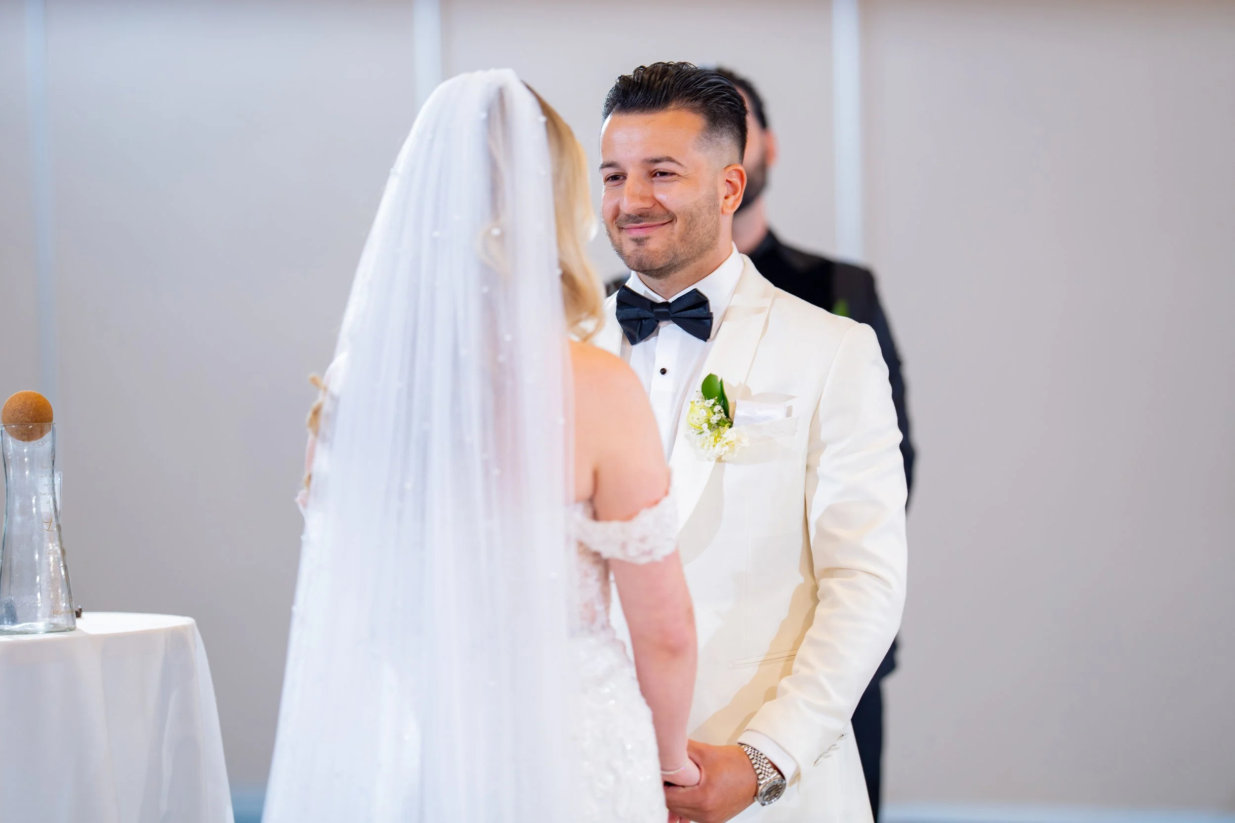 Emotional groom crying with tears of joy during the ceremony at HILTON TAMPA DOWNTOWN; professional wedding photography by Star Visual Art, Tampa.
