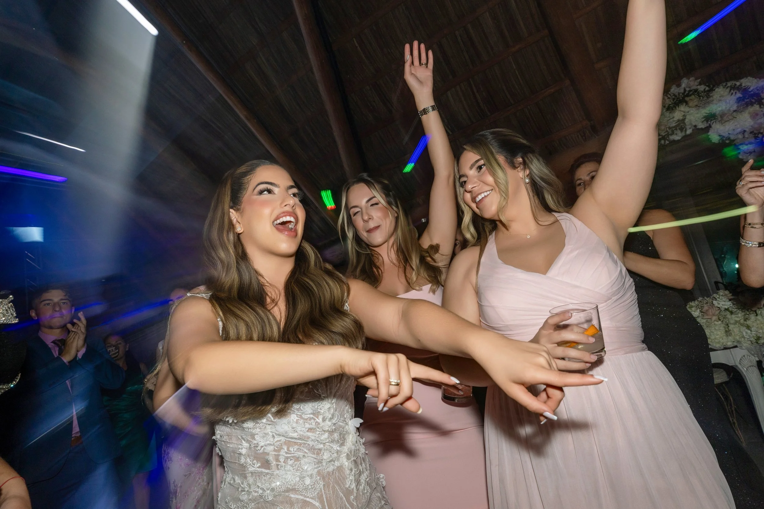 Group of women dancing and enjoying at a party or celebration, smiling and having fun.