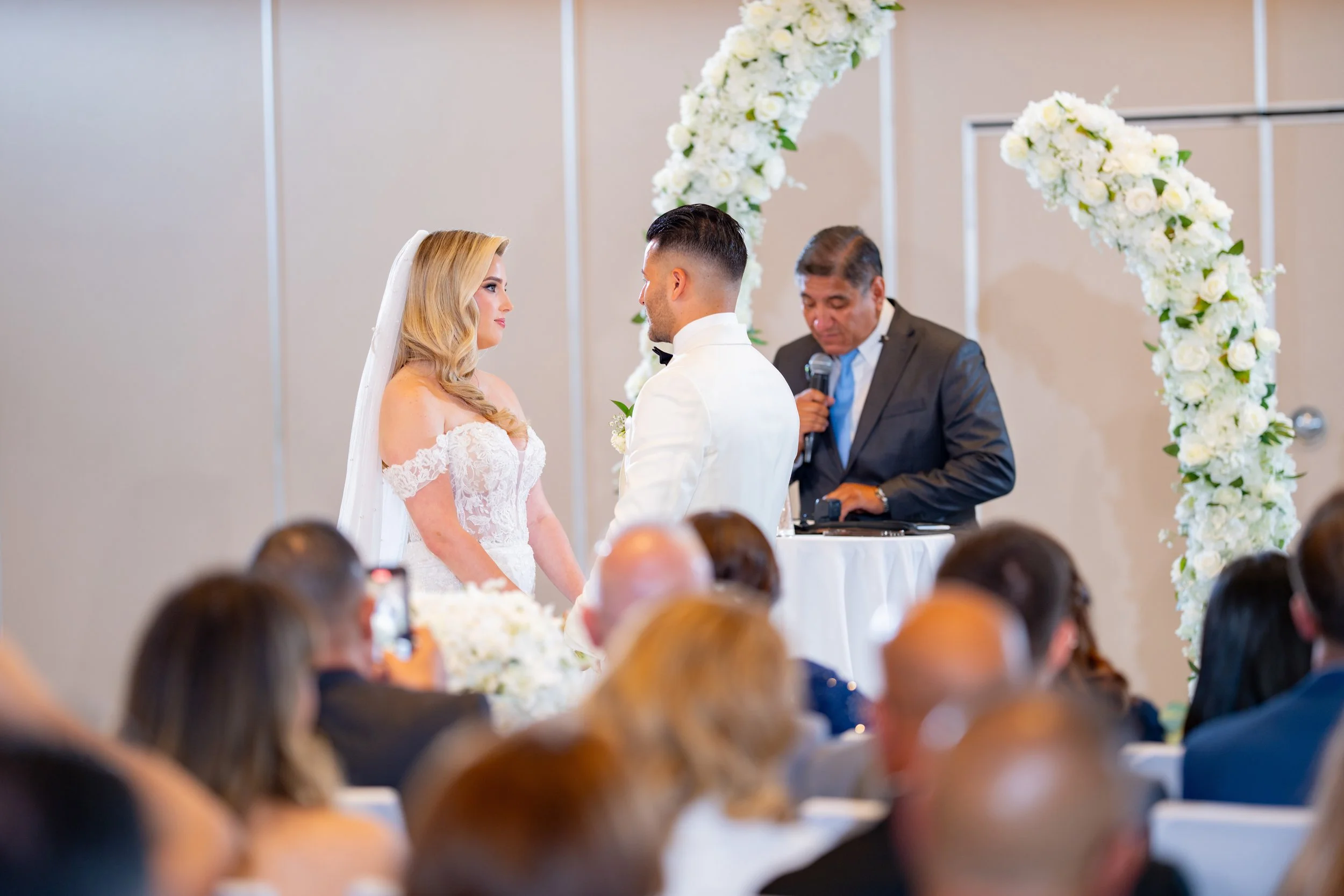 Emotional groom crying with tears of joy during the ceremony at HILTON TAMPA DOWNTOWN; professional wedding photography by Star Visual Art, Tampa.